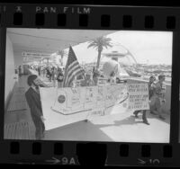 Pan American Airways employees carrying banner reading "Pan AM is Made in USA Support Our U.S. Airline.." during demonstration at LAX, Calif., 1974