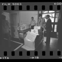 State Senator Alan Robbins and Reverend W. C. Jackson wheeling antibusing initiative petitions into the Los Angeles County Registrar-Recorder's office, 1978