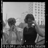 Two women on smoggy day in downtown Los Angeles, Calif., 1964