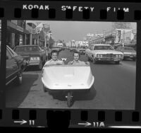 Steven Goldsmith and Rich Blum driving their "People Powered Vehicle," pedal car down Fairfax Avenue in Los Angeles, Calif., 1973