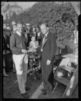 Golfer Craig Wood being handed a check by an unidentified man at the Los Angeles Open, 1933