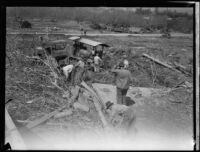 Workers using tractors to clear flood debris after the flood resulting from the failure of the Saint Francis Dam, Santa Clara River Valley (Calif.), 1928