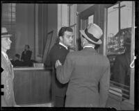 Edward Hill, bank guard, turns to talk to a man after the bank was robbed, Los Angeles, 1936