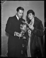 Ivan Lebedeff and Norma Boleslavsky with an artifact from the collection of Dr. Armond Hammer, on eshibit at Bollock's Wilshire, Los Angeles, 1932