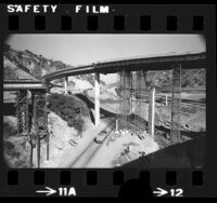 Golden State and Antelope Valley freeway bridges encased by formwork during earthquake repair work at Weldon Canyon south of Santa Clarita, 1973