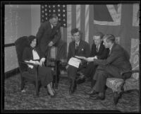 Carmen Balfour, Lord Annesley, Patrick MacGill, Robert W. Major and Francis Evans seated with papers, Los Angeles, 1936