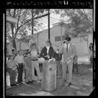 Apostolic Tabernacle's Reverend David Elms and youths at book burning in Bellflower, Calif., 1973