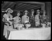 Women delegates from the Retail Merchants' Credit Association convention offer fruit, Los Angeles, 1926