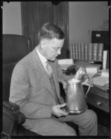 Judge Charles D. Ballard holding metal pitcher, [1935-1939?]