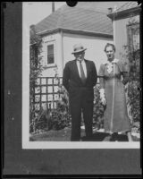 Harry Meagher, murder victim, and an unidentified woman in front of a house, 1930-1933