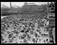 Crowd celebrating the Fourth of July on Venice Beach beach near Lick Pier and Ocean Park Pier, Venice, 1929