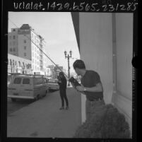 Brad Ignatowski and Karen Sweeney trying out their Christmas gift, walkie-talkies, Los Angeles, Calif., 1965