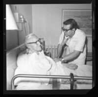 Robert Messerly, student nurse, attends to Holger Larson at Good Samaritan Hospital, Los Angeles, 1971