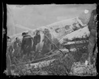 Rescuers congregate around the fuselage of a wrecked Western Air Express plane, Newhall (vicinity), 1937