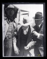 James P. Watson, murder suspect, escorted by two sheriffs, Los Angeles, 1920