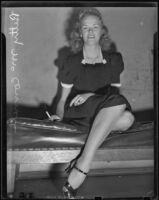 Betty McConnell smiles from a bench, Los Angeles, 1938