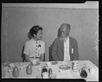 Miss Lil' Tokyo Alice Watanabe and K. Baba at at the banquet at the Kawafuku Cafe for the 2nd annual Nisei Festival, Los Angeles, 1935