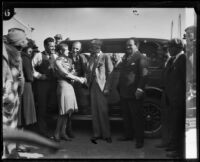 Stunt driver Hayward Thompson shakes hand with a woman, Los Angeles, 1927