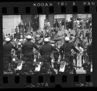 Mayor Tom Bradley on podium with LAPD motorcycle drill team lined up before him during his inauguration in Los Angeles, Calif., 1973