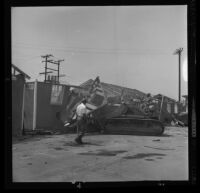 Jerry Gould supervises Bunny Asher as he bulldozes a house used for editing at Hal Roach Studios, Culver City, 1963