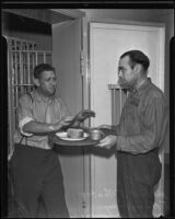 Officer J. Humphrey offers food to Herbert J. Teater, Los Angeles, 1925