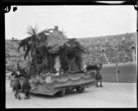 Custer Avenue School students in costume with float depicting California history, Shriners' parade, Los Angeles Memorial Coliseum, Los Angeles, 1925