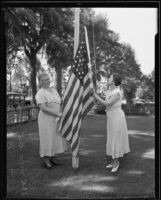 Mrs. B. L. Goodhart and Mrs. B. O. Holbrook raise the American flag, Los Angeles, 1935