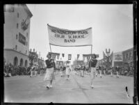 Young women carrying the "Huntington Park High School Band" banner in the Tournament of Roses Parade, Pasadena, 1931