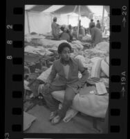 Jose Alvarez sitting on a cot in the Tent City for the homeless in Los Angeles, Calif., 1984