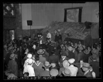 Crowd listening to a barker during opening week tour of Los Angeles Union Station in 1939