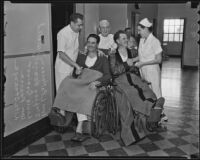 Police Officers William Patterson and Steven Henzel thank nurses Louis Greiner, William Pearce, and Lila Strange as they leave the hospital to eat Christmas dinner at home, Los Angeles, 1935