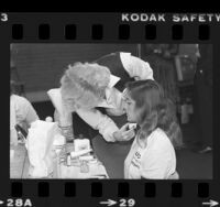 Sue Cary, Avon makeup artist, demonstrates for USC women athletes, 1979