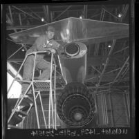 Chuck Yeager checks rocket installation on Lockheed Starfighter at Edwards Air Force Base, Calif., 1963