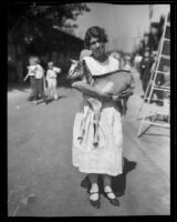 Woman holding a goat at the Los Angeles County Fair, Pomona, 1932