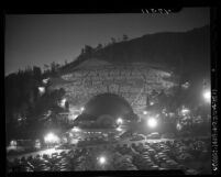 View from across parking lot of stage and crowd on hillside during performance of Margaret Truman at the Hollywood Bowl, Calif., 1947
