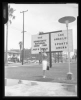 Woman posing in front of the Memorial Sports Arena sign, Los Angeles, 1960