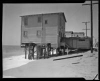 Beach house threatened by tide, Newport Beach, 1933