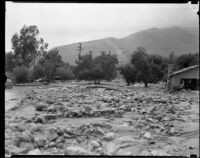 Mud-and-rock-strewn area next to a destroyed house after a catastrophic flood and mudslide, La Crescenta-Montrose, 1934