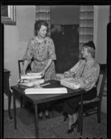 Daughters of the American Revolution members Mrs. George Craig and Nelle Holbrook wrap presents, 1936