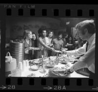 Cast members of theater production of "Hair" taking a dinner break, Los Angeles, Calif