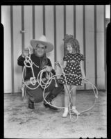 Ken Maynard shows Joan Holt rope tricks, Van Nuys, 1936