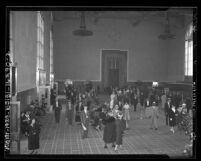 People in the east wing ticket concourse of Los Angeles Union Station during opening week in 1939