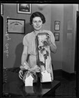 Dorothy Oaks holds gifts for Judge Thomas P. White and Charles R. Morfoot who were working the Guttman-Sewell case, Los Angeles, 1935