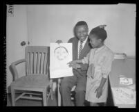 UCLA professor, Dan Kunene with his daughter Leziwe and one of her drawings in Los Angeles, Calif., 1965