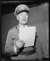 Colonel Reginald Barlow reads from a script, Los Angeles, 1934 — Calisphere