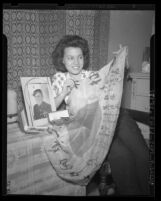 Odena Ervin, widow of Marine Arthur Ervin, displaying Japanese Flag found wrapped around her husband's belongings, 1945