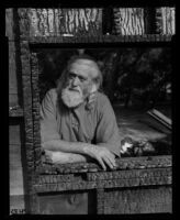 Patriarch Wilber Foster Yates stands among some remnants of the headquarters of Fountain of the World. B. 1958