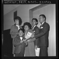 Navy chief steward Mauro Quimson with his children as they become U.S. citizens in Los Angeles, Calif., 1963