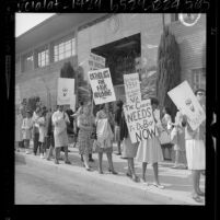 Pickets march at Los Angeles' Catholic chancery in support of Compton priest Father William DuBay, 1964