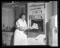 Ethyl Rogers demonstrating built-in electric oven at Home Show in Los Angeles, Calif., 1940